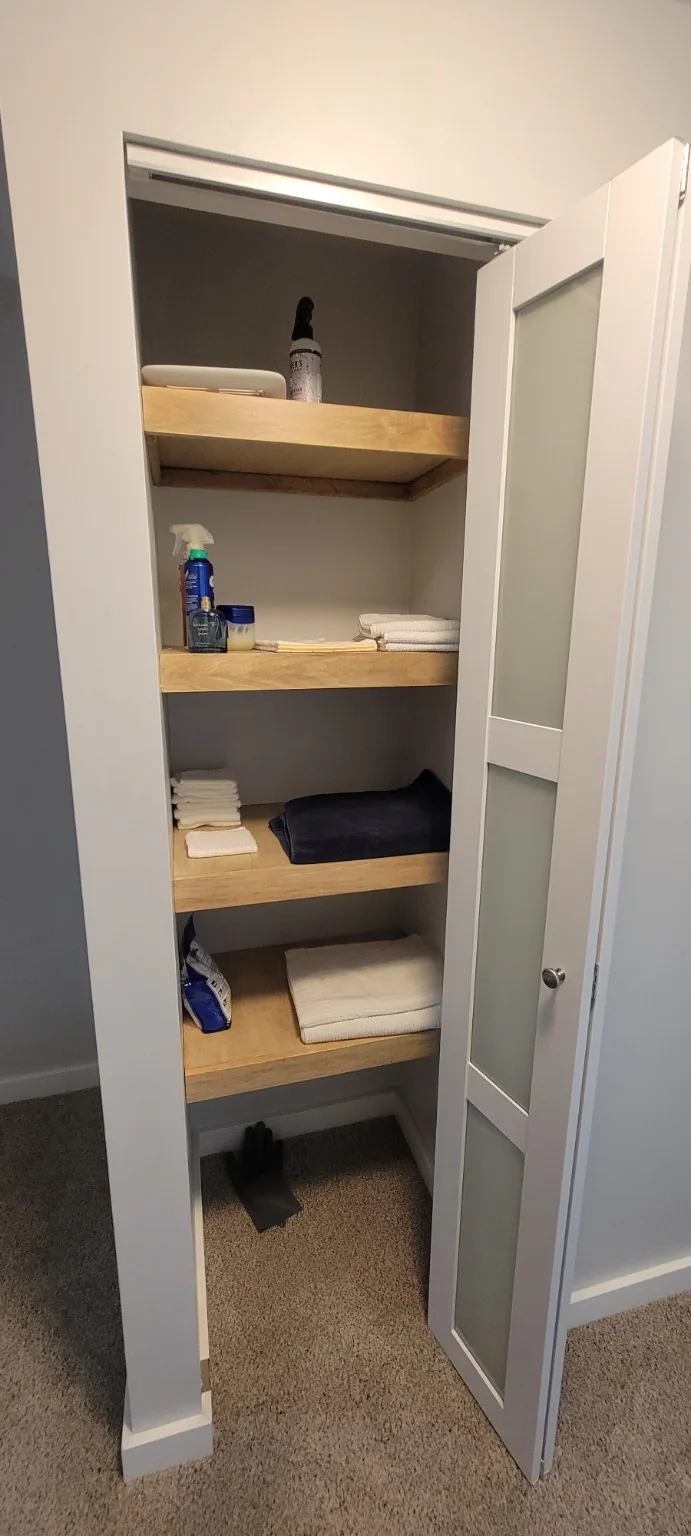 Built-in closet shelving with glass-panel door
