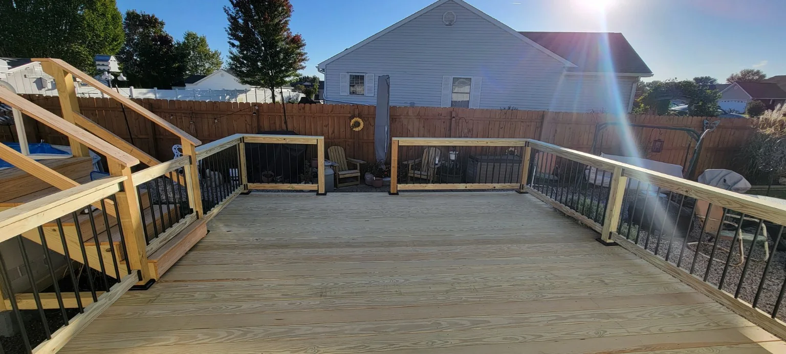 Finished wood deck with black rail balusters