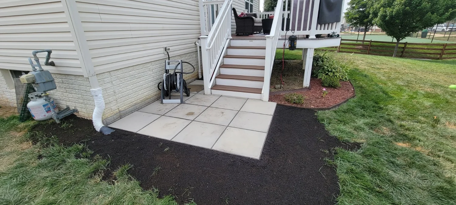 Small paver landing beside exterior stairs
